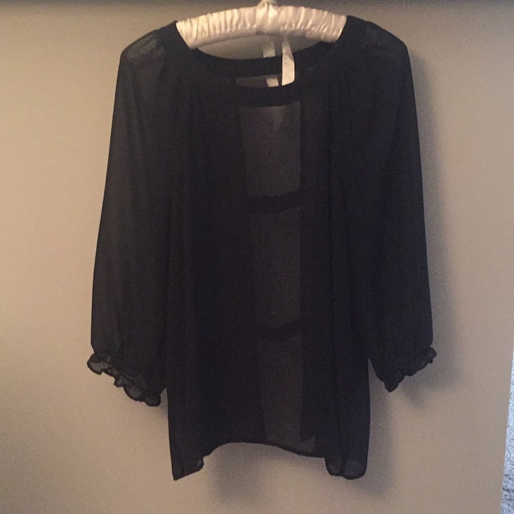 Sheer black top. Open in the back.
